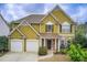 Charming two-story home with a two-car garage, stone accents, and a well-manicured lawn at 4461 Kentland Dr, Acworth, GA 30101