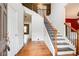 Bright foyer with hardwood floors, staircase, and white trim at 4461 Kentland Dr, Acworth, GA 30101