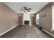 Cozy living room with a stone fireplace, ceiling fan, and ample natural light at 4461 Kentland Dr, Acworth, GA 30101