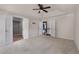 Bright, carpeted main bedroom with a tray ceiling and multiple interior door entrances at 4461 Kentland Dr, Acworth, GA 30101