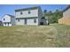 View of a large backyard with a grassy area leading to the two-story home's back door at 5675 Laurel Ridge Cir, Atlanta, GA 30344