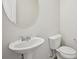 Clean half-bathroom features a pedestal sink and toilet at 5675 Laurel Ridge Cir, Atlanta, GA 30344