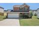 Charming two-story brick home with a well-maintained front yard and an attached two-car garage at 5675 Laurel Ridge Cir, Atlanta, GA 30344