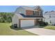 Angle view of brick home with a well-maintained front lawn and attached two car garage at 5675 Laurel Ridge Cir, Atlanta, GA 30344