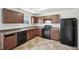 Well-equipped kitchen with wooden cabinets and black appliances at 5675 Laurel Ridge Cir, Atlanta, GA 30344