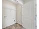 A laundry room with tile floors has washer and dryer hookups and a wire shelf at 5675 Laurel Ridge Cir, Atlanta, GA 30344