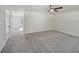 Large living room with neutral carpet, ceiling fan, and large door to the outdoors at 5675 Laurel Ridge Cir, Atlanta, GA 30344