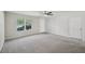 An empty living room features neutral carpet, ceiling fan, and a large window at 5675 Laurel Ridge Cir, Atlanta, GA 30344