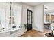 Open-concept entryway and dining area filled with natural light, hardwood floors, and modern decor at 1010 Violet Sw St # A, Atlanta, GA 30310