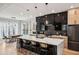 Modern kitchen features an expansive island with marble countertops and sleek, black cabinetry at 1010 Violet Sw St # A, Atlanta, GA 30310