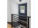 Staircase features a modern railing and statement light fixture that enhances the space at 1010 Violet Sw St # A, Atlanta, GA 30310