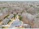 An aerial view of a neighborhood with mature trees and a pond at 1190 Mosspointe Dr, Roswell, GA 30075