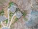 Aerial view showcases a house with a pool next to a serene lake, surrounded by lush greenery at 1190 Mosspointe Dr, Roswell, GA 30075