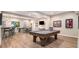 Spacious basement featuring a bar, pool table, and dining area for entertainment at 1190 Mosspointe Dr, Roswell, GA 30075
