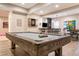 Entertaining basement with pool table, dart board, tv and bar area at 1190 Mosspointe Dr, Roswell, GA 30075
