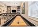 Basement with wet bar, beverage fridge, bar seating, and shuffleboard at 1190 Mosspointe Dr, Roswell, GA 30075