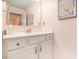 Well-lit bathroom with a white vanity and decorative mirror at 1190 Mosspointe Dr, Roswell, GA 30075