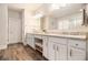 Bright bathroom with white cabinets, double sinks, granite countertops, and a separate toilet room at 1190 Mosspointe Dr, Roswell, GA 30075