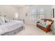 Bright bedroom with natural light, two windows, and a cozy wicker bench with pillows at 1190 Mosspointe Dr, Roswell, GA 30075