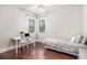 Bedroom features wooden floors, a small bed, and two windows at 1190 Mosspointe Dr, Roswell, GA 30075