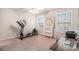 Bedroom featuring carpet flooring, two windows, and an exercise machine at 1190 Mosspointe Dr, Roswell, GA 30075