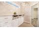 Walk-in closet with custom built-in shelving, drawers, and a window for natural light at 1190 Mosspointe Dr, Roswell, GA 30075