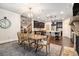 Elegant dining area featuring hardwood floors, modern chandelier, and view into the kitchen area at 1190 Mosspointe Dr, Roswell, GA 30075