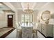 Bright dining room featuring a coffered ceiling, large windows, and a stylish chandelier over a dining table at 1190 Mosspointe Dr, Roswell, GA 30075