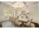 Elegant dining room with coffered ceiling, chandelier, and large windows at 1190 Mosspointe Dr, Roswell, GA 30075