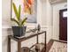 Entryway table featuring dark wood, a glass top, and decorative art pieces at 1190 Mosspointe Dr, Roswell, GA 30075