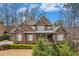 Charming brick home featuring manicured landscaping, a well-kept lawn, and a covered entryway at 1190 Mosspointe Dr, Roswell, GA 30075