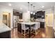 Beautiful kitchen with granite countertops, stainless steel appliances, and a center island with bar seating at 1190 Mosspointe Dr, Roswell, GA 30075