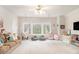 Bright playroom with hanging chairs, comfortable seating, and large windows at 1190 Mosspointe Dr, Roswell, GA 30075