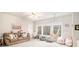 Bright playroom features large windows, a sofa, and hammock chairs at 1190 Mosspointe Dr, Roswell, GA 30075