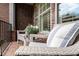 Cozy porch seating area with wicker chairs, providing a relaxing outdoor space with brick flooring at 1190 Mosspointe Dr, Roswell, GA 30075