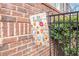 Charming 'Hello' yard flag displayed in front of a brick wall with greenery at 1190 Mosspointe Dr, Roswell, GA 30075