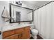 Bright bathroom with a wood vanity, framed mirror, and a shower and tub combination at 2814 Pine Valley Nw Way, Kennesaw, GA 30152