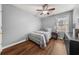 Comfortable bedroom with wood floors, a ceiling fan, and a window for natural light at 2814 Pine Valley Nw Way, Kennesaw, GA 30152