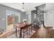 Dining area featuring hardwood floors, access to the backyard, and a modern spiral staircase at 2814 Pine Valley Nw Way, Kennesaw, GA 30152