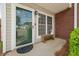 Inviting front porch featuring a glass door, ample natural light, and a cozy wooden bench at 2814 Pine Valley Nw Way, Kennesaw, GA 30152