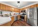 Well-lit kitchen features stainless appliances, wood cabinets, and sleek countertops at 2814 Pine Valley Nw Way, Kennesaw, GA 30152