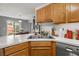 Bright kitchen with stainless sink, wood cabinets, and a view to the outdoor dining area at 2814 Pine Valley Nw Way, Kennesaw, GA 30152