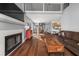 Inviting living room featuring wood floors, a fireplace, and an open floor plan to the dining area at 2814 Pine Valley Nw Way, Kennesaw, GA 30152
