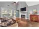 Bright living room with hardwood floors, fireplace, large windows, and a soaring vaulted ceiling at 2814 Pine Valley Nw Way, Kennesaw, GA 30152