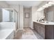 Bathroom with a glass shower, gray cabinets, and double sinks at 321 Silver Leaf Trce, Douglasville, GA 30134