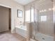 Bathroom with a soaking tub and a glass-enclosed shower at 321 Silver Leaf Trce, Douglasville, GA 30134