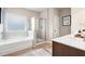 Bright bathroom with a soaking tub, glass-enclosed shower, and neutral color palette at 321 Silver Leaf Trce, Douglasville, GA 30134