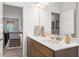 Bright bathroom featuring double sinks, a large mirror, and tile flooring at 321 Silver Leaf Trce, Douglasville, GA 30134