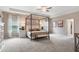 Spacious bedroom featuring a tray ceiling, ceiling fan, and a stylish canopy bed at 321 Silver Leaf Trce, Douglasville, GA 30134