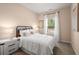 Charming bedroom with a white iron bed, white curtains, and natural light at 321 Silver Leaf Trce, Douglasville, GA 30134